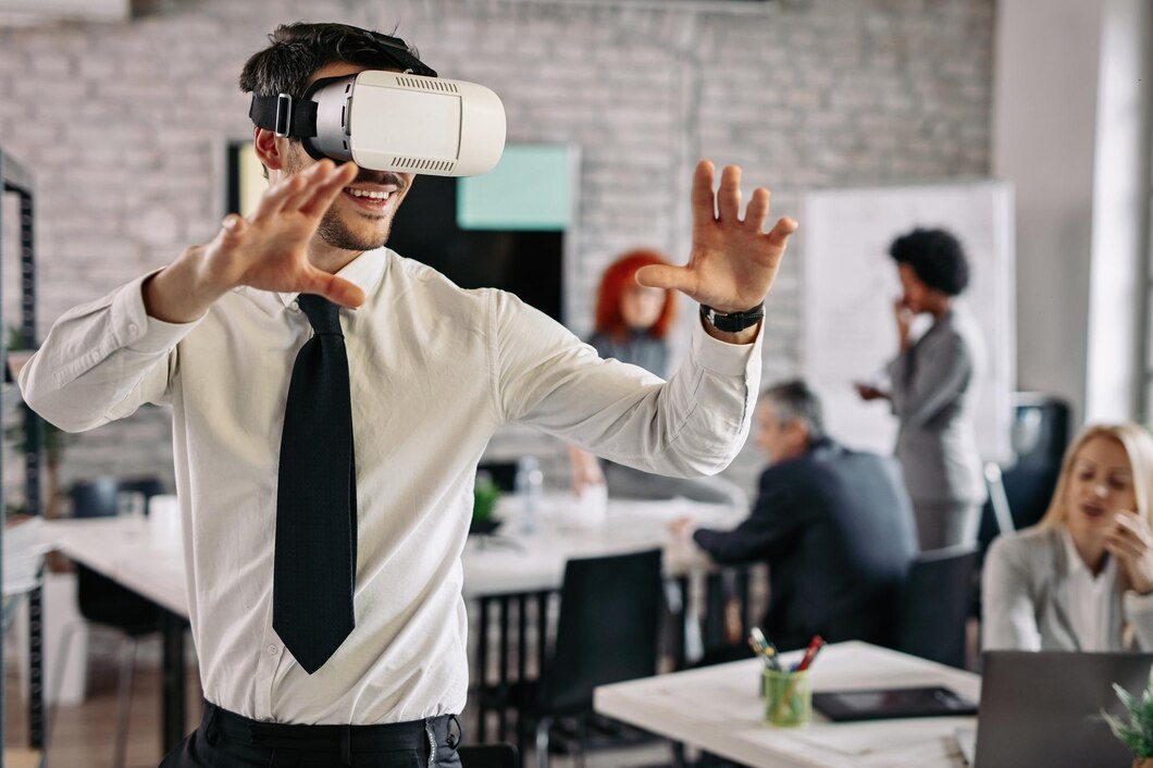 playful-businessman-wearing-virtual-reality-headset-having-fun-office-there-are-people-background_637285-32